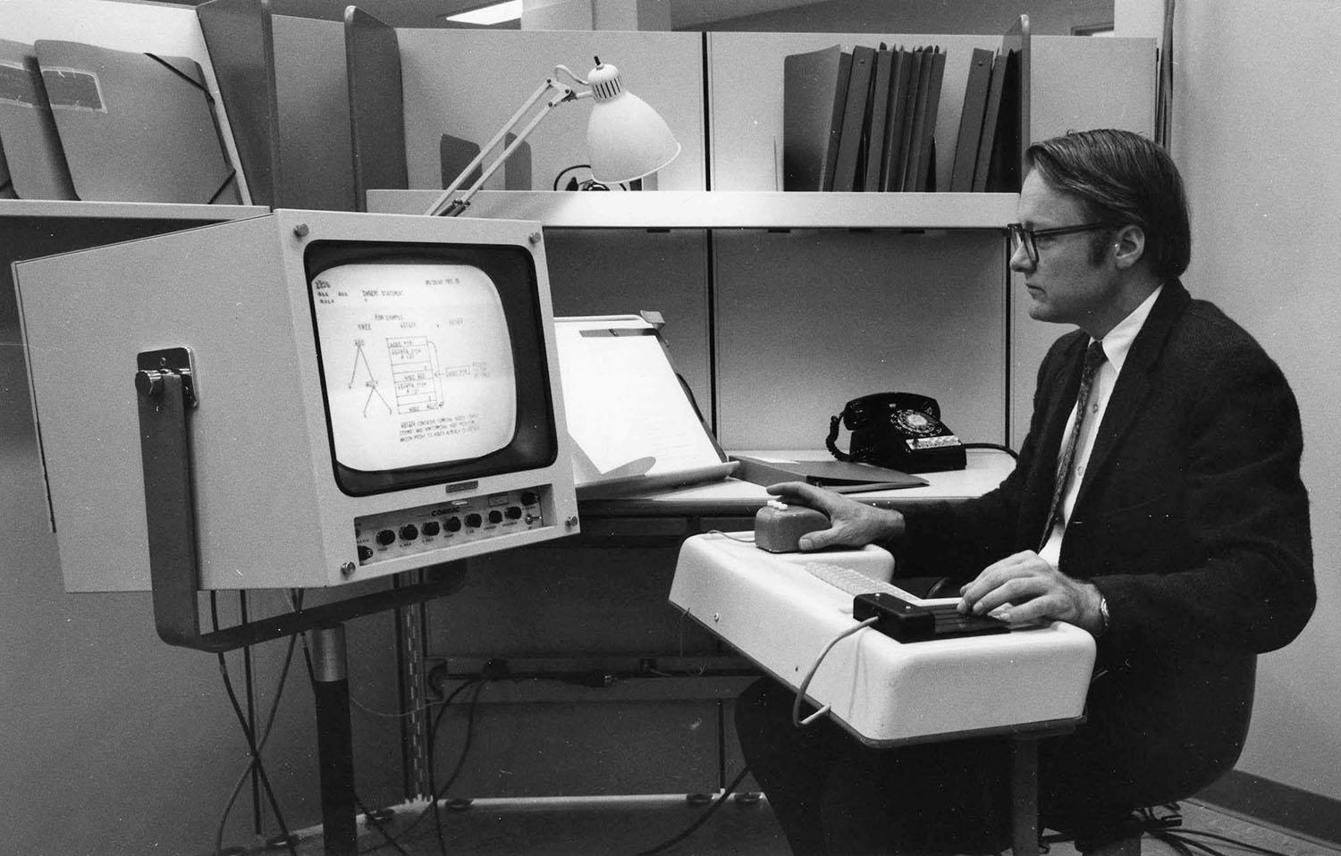 A man interfacing with an old computer